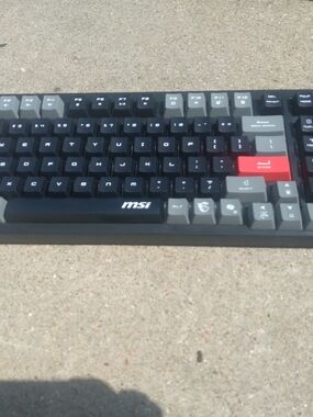 MSI Black Keyboard with Gray Modifiers and Red Accent Key